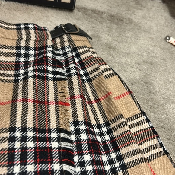 Toddler plaid skirt measures approximately 10 1/2 inches across the waist. - Picture 8 of 8